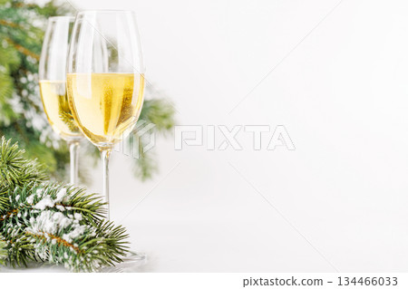Champagne glasses and snowy fir on white 134466033