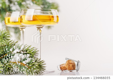 Champagne glasses and snowy fir on white 134466035