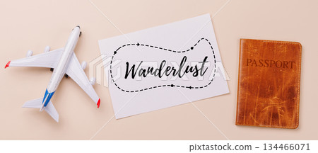 Travel-themed flat lay with card, passport, toy airplane 134466071