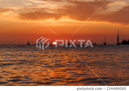Sunset over the sea with sailing boats on the horizon Sunset over the sea with sailing boats on the horizon 134466080