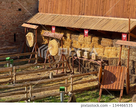 Medieval archery range beside fortress wall. Recreation, historical heritage and outdoor sporting tradition. Medieval archery range beside fortress wall. Recreation, historical heritage and outdoor sporting tradition. 134466535