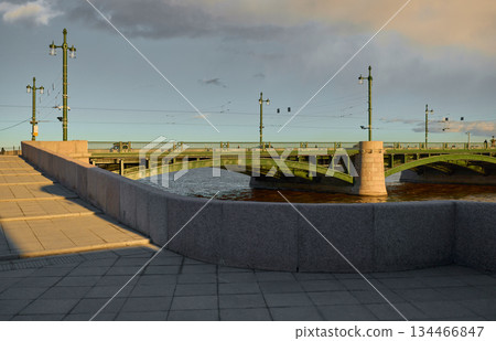 view of the Birzhevoy bridge and Rostral columns at sunset, lampposts on the bridge, Neva River with a view of the arrow of Vasilyevsky Island with rostral columns view of the Birzhevoy bridge and Rostral columns at sunset, lampposts on the bridge, Neva River with a view of the arrow of Vasilyevsky Island with rostral columns 134466847