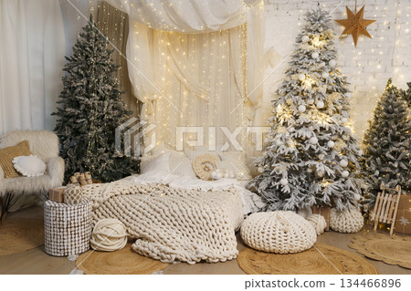 Cozy Scandinavian Christmas kids room with snowy trees, lights and wooden toys Cozy Scandinavian Christmas kids room with snowy trees, lights and wooden toys 134466896