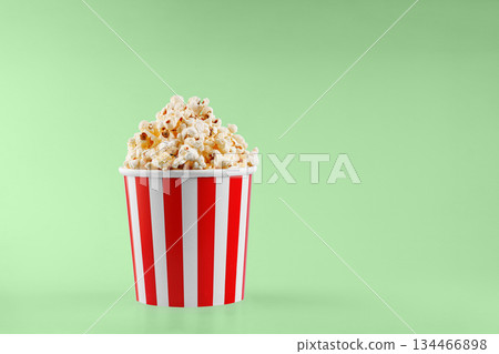 Classic red striped popcorn cardboard cup on Green background Classic red striped popcorn cardboard cup on Green background 134466898