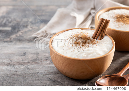 Rice pudding on wooden bowl Rice pudding on wooden bowl 134467008