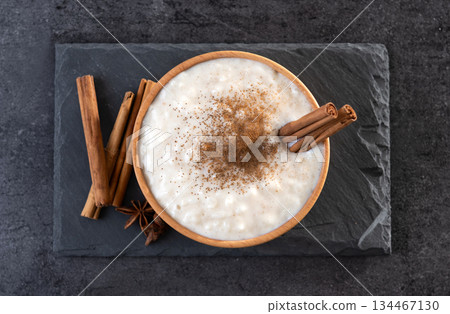 Rice pudding on wooden bowl Rice pudding on wooden bowl 134467130