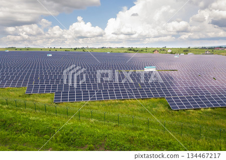 Aerial view of solar power plant on green field. Electric panels for producing clean ecologic energy. Aerial view of solar power plant on green field. Electric panels for producing clean ecologic energy. 134467217
