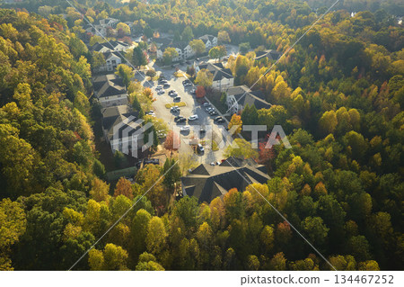 Aerial view of new apartment houses between yellow trees in South Carolina suburban area in fall season. Real estate development in american suburbs 134467252