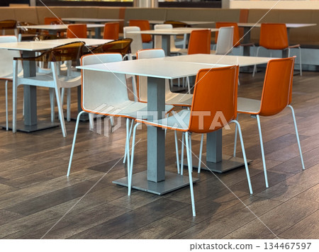 Food court with orange chairs. Modern dining, social life, and public interior. Food court with orange chairs. Modern dining, social life, and public interior. 134467597