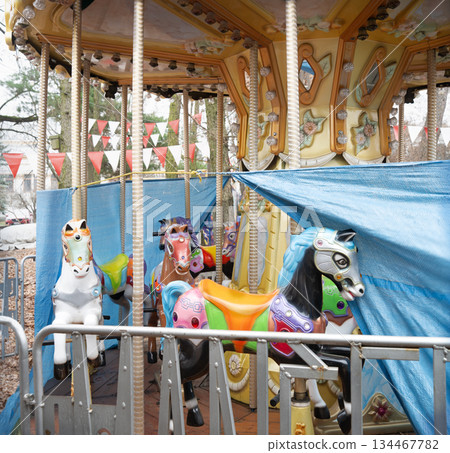White ponies on an abandoned carousel White ponies on an abandoned carousel 134467782