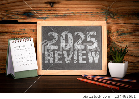 2025 Review. Desk Calendar and Chalkboard Message 2025 Review. Desk Calendar and Chalkboard Message 134468691