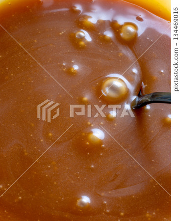 freshly cooked caramel sauce background 134469016