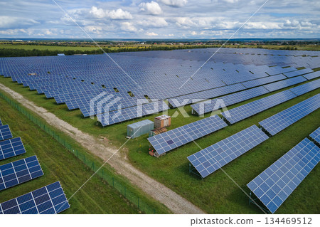 Aerial view of big sustainable electric power plant with many rows of solar photovoltaic panels for producing clean electrical energy. Renewable electricity with zero emission concept 134469512