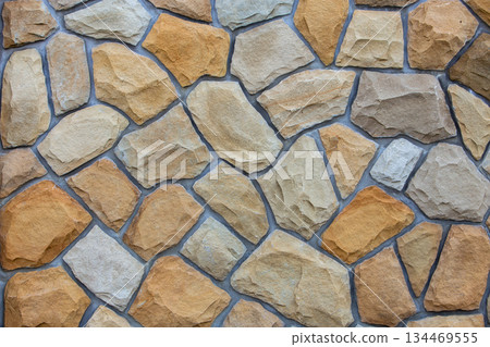 Abstract wall surface made from sand stones for usage as background. 134469555
