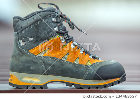 A leather trekking hiking winter boot on blurred background A leather trekking hiking winter boot on blurred background 134469557