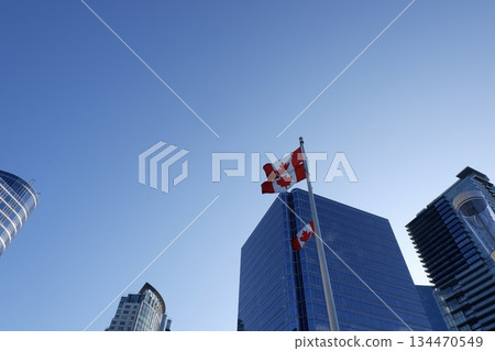 Canadian flag and skyscraper landscape Canadian flag and skyscraper landscape 134470549