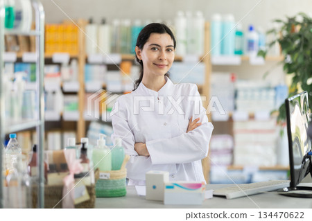 woman pharmacist stands in a pharmacy woman pharmacist stands in a pharmacy 134470622
