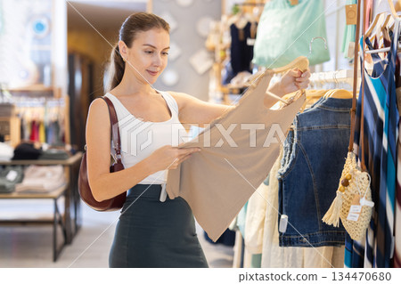 Young woman choosing tank top 134470680