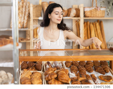 Young woman choosing pastries in bakery Young woman choosing pastries in bakery 134471306