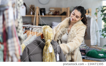 Armenian woman choosing clothes for autumn and winter in the store Armenian woman choosing clothes for autumn and winter in the store 134471395
