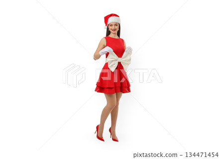 Woman wearing red dress and Santa hat holding large bow, isolated, PNG Woman wearing red dress and Santa hat holding large bow, isolated, PNG 134471454