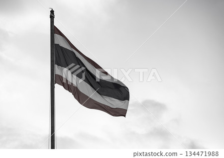 A Thailand national flag blowing by wind against with sadness tone. The flag of Thailand is a symbol of being a country. A Thailand national flag blowing by wind against with sadness tone. The flag of Thailand is a symbol of being a country. 134471988