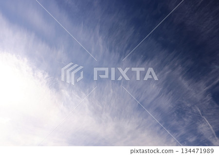 Nature Weather Cirrus, Dense Clouds. Thick clouds that blur the outline of the sun, with many thin, thread-like streamlines at the edge of the clouds. 134471989