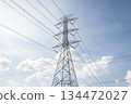 A big transmission tower against blue sky.  134472027