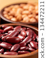 Raw red kidney beans in wooden bowl. Close-up 134472211
