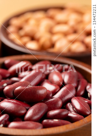 Raw red kidney beans in wooden bowl. Close-up 134472211
