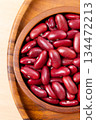 Raw red kidney beans in wooden bowl. Top view 134472213