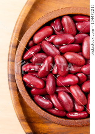Raw red kidney beans in wooden bowl. Top view 134472213