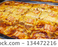 Cheese and slice bacon lasagne on tray. Close up 134472216