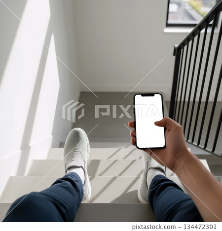 first person view of legs and smartphone on stairs 134472301