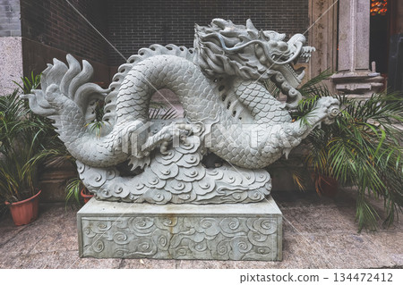 Oct 29 2025 Stone Dragon Statue Beside Temple Entrance With Greenery 134472412