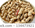 A lot of shelled peanuts in a bamboo basket on a white background 134473921
