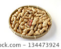 A lot of shelled peanuts in a bamboo basket on a white background 134473924