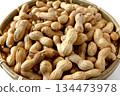 A lot of shelled peanuts in a bamboo basket on a white background 134473978
