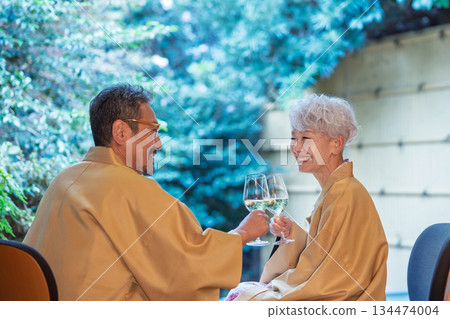 Senior couple drinking wine on the veranda. Photo courtesy of Ito Ryokuyo. 134474004