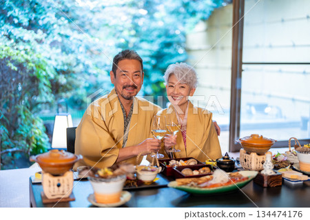 Senior couple eating at a hot spring inn Senior couple eating at a hot spring inn 134474176