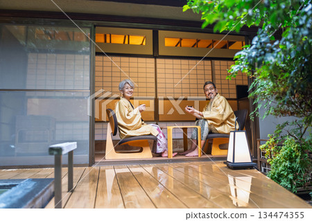 Senior couple relaxing at a traditional Japanese inn. Photo courtesy of Ito Ryokuyo. Senior couple relaxing at a traditional Japanese inn. Photo courtesy of Ito Ryokuyo. 134474355