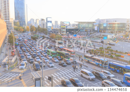 Evening rush hour: A crowded train station in Seoul with cars and buses Evening rush hour: A crowded train station in Seoul with cars and buses 134474658
