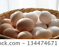 Two kinds of large fresh eggs on a colander 134474671
