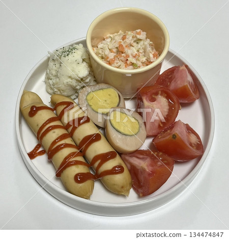 A delightful brunch spread featuring a mix of savory and sweet dishes, including fresh pastries, eggs, seasonal fruits, and a hot beverage. A perfect mid-morning indulgence. 134474847