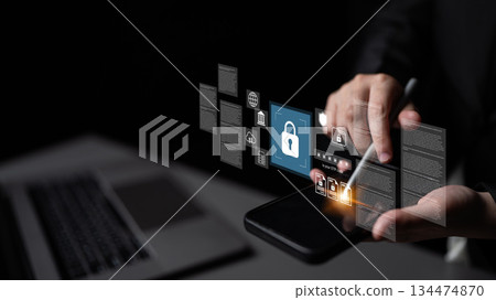 Hands Holding Smartphone with Security Icons and Digital Interface Elements Representing Cybersecurity and Data Protection Concepts Gantry 134474870