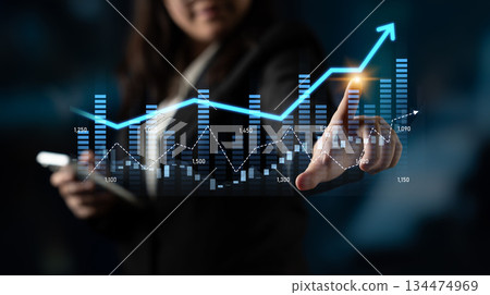Businesswoman Using Digital Technology to Analyze Growth Trends in Graphs and Data Visualizations with Abstract Background Scalp Businesswoman Using Digital Technology to Analyze Growth Trends in Graphs and Data Visualizations with Abstract Background Scalp 134474969