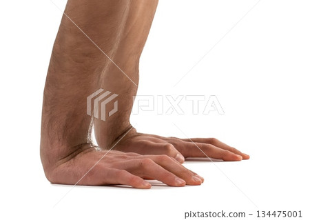 Close-up of man's arms and hands in a yoga position demonstrating strength and balance on a white background Close-up of man's arms and hands in a yoga position demonstrating strength and balance on a white background 134475001