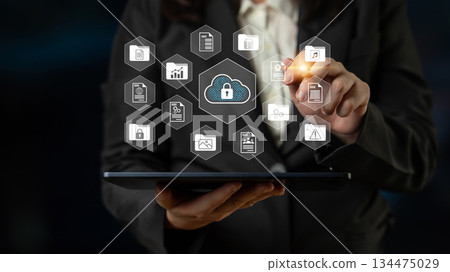 Business Professional Engaging with Digital Cloud Security Interface on Tablet Device in Modern Office Environment Gantry 134475029