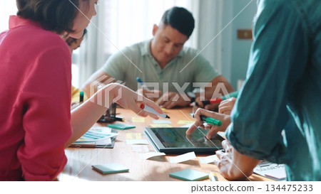 Top view of manager writing idea on sticky notes and explain idea. Symposium. 134475233