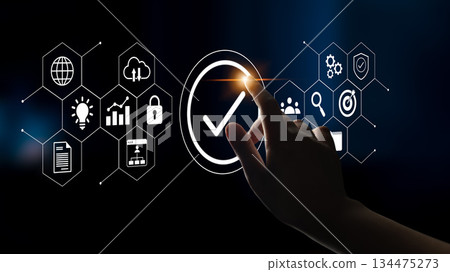 Abstract digital image showcasing a hand selecting a checkmark from interconnected icons representing technology concepts, innovation, and security in a modern environment Gantry 134475273